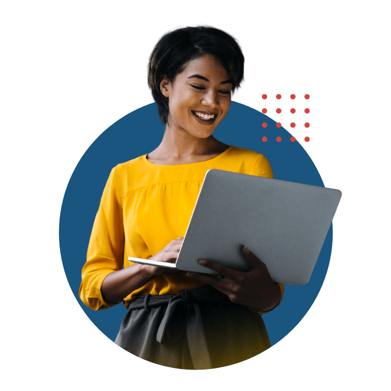 A black woman smiles while looking at the screen of a laptop that she's holding.